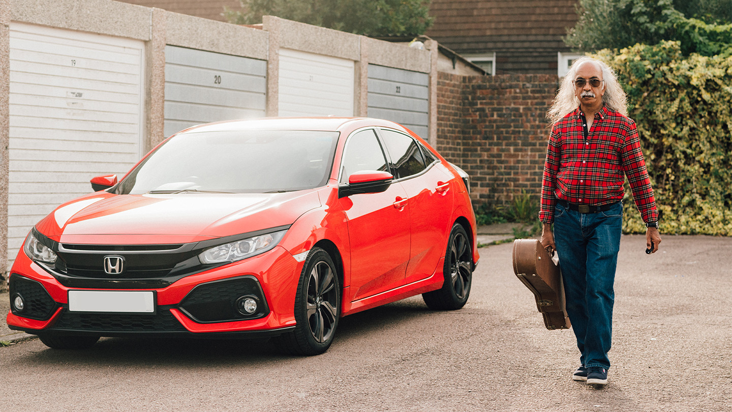 Nigel walking alongside his car